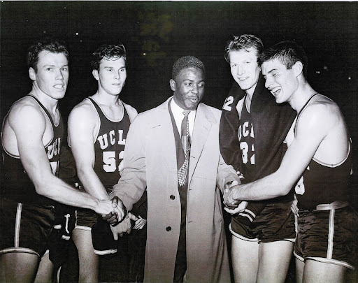Norman (#52) celebrates with Jackie Robinson following UCLA's victory over CCNY at Madison Square Garden, December 1949